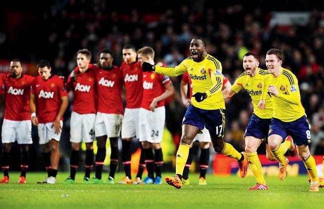 Picture of contrasts: Jozy Altidore (arms outstretched), Phil Bardsley and Adam Johnson (right) of Sunderland celebrate their 2-1 victory in the penalty shootout during the League Cup semi final, second leg at Old Trafford on Wednesday. Pic/Getty Images