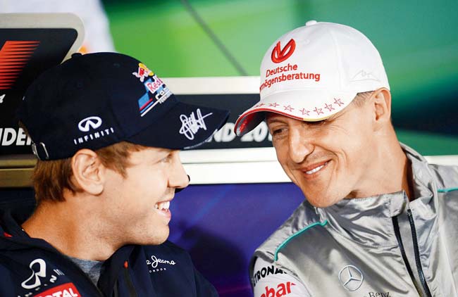 Red Bull’s Sebastian Vettel chats with then Mercedes GP’s Michael Schumacher during a drivers press conference at Hockenheimring in 2012. Pic/Getty Images