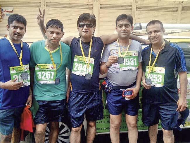 Amit Kasat (fourth from left) is still recuperating in hospital after he collapsed a kilometre away from the finish line during the half-marathon