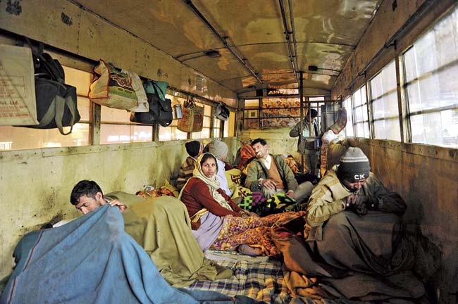 Buses are becoming makeshift ‘night shelters’ for homeless patients in Delhi. Each bus can accomodate 28 people at a time. Pic/AFP