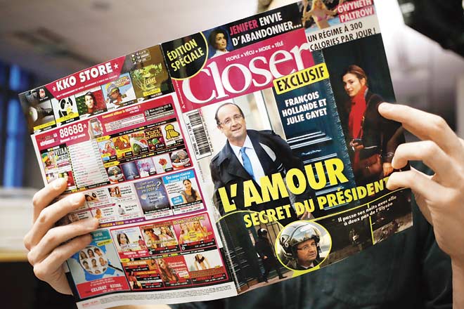 A French citizen reads Closer, which reported on French President Francois Hollande’s alleged affair with actress Julie Gayet. Pic/AFP