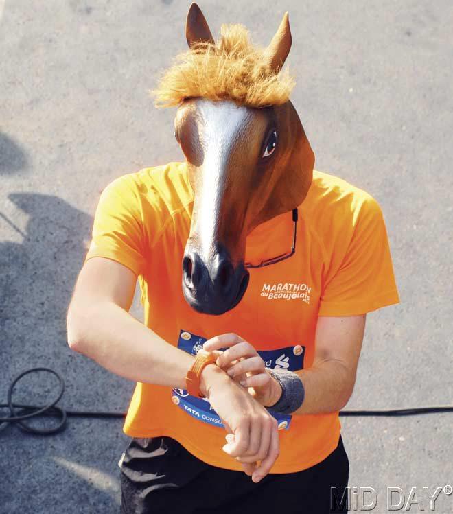 A participant with a horse head piece runs in the marathon. Pic/Atul Kamble