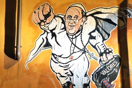 Pope as Superman: Vatican tweets graffiti of hero pontiff 