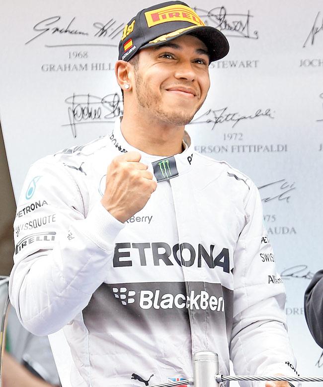 Lewis Hamilton celebrates on the podium. Pic/Getty Images