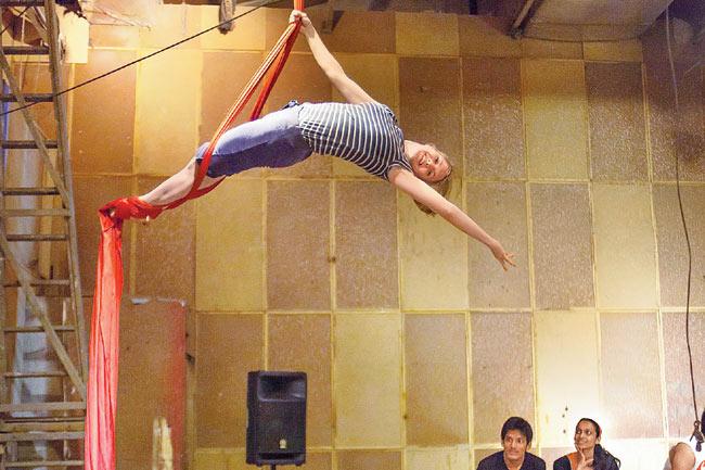 Aerial silk is performed while hanging from a fabric