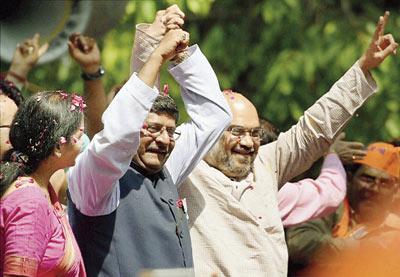 Amit Shah and Ravi Shankar Prasad celebrate after BJP’s huge victory at the party HQ in New Delhi. Pic/PTI