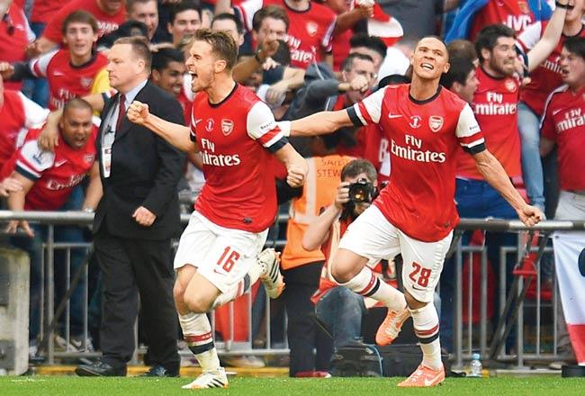 Aaron Ramsey (left) celebrates Arsenal