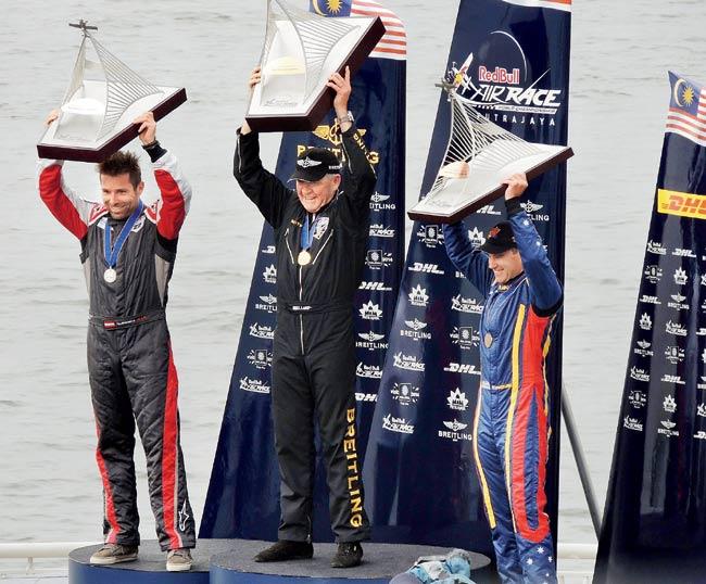 Red Bull Air Race winner Nigel Lamb (centre), second-placed Hannes Arch (left) and third-place winner Matt Hall with their trophies atop the podium in Putrajaya, Malaysia yesterday