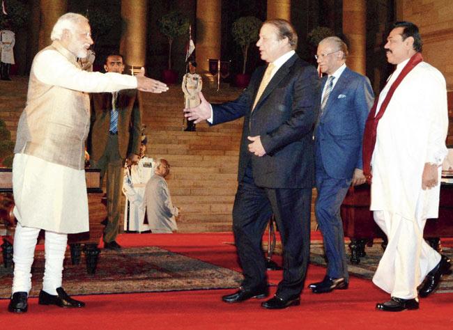 Newly sworn-in Prime Minister Narendra Modi accepts greetings from Pakistan’s Prime Minister Nawaz Sharif after the swearing-in ceremony of the NDA government at Rashtrapati Bhavan in New Delhi on Monday. Pic/PTI