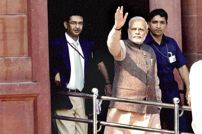 Prime Minister Narendra Modi waves as he comes out of the PMO after taking over, in New Delhi. Pics/PTI