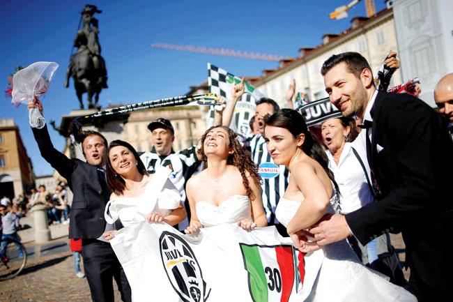 Supporters celebrate after Juventus won the Italian Scudetto in Piazza San Carlo in Turin yesterday. Pic/AFP