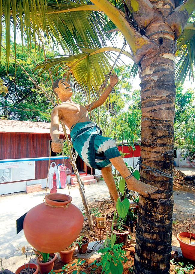 A sculpture depicting a man climbing a coconut tree. 