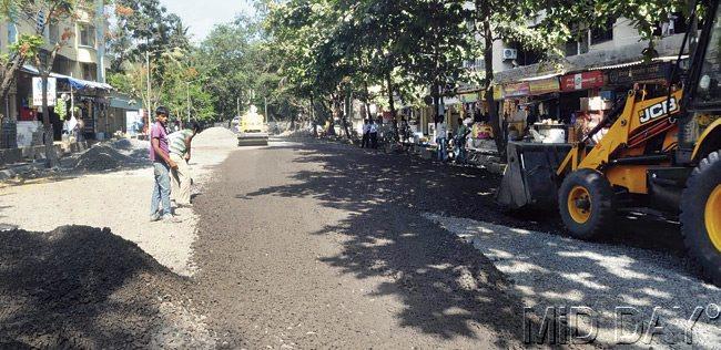 Laying of asphalt is on, but residents say the road did not need repairs and would have lasted another monsoon. Pic/Nimesh Dave