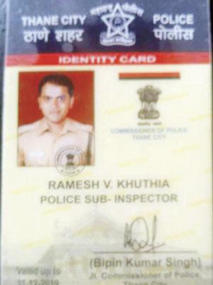 Ramesh Khutia and his fake police ID card, which says he is a police sub-inspector