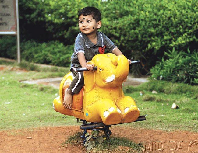 This kid seemed to be happily playing on this elephant ride at Parel garden