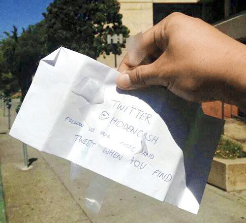 After each money drop, a tweet goes out from @HiddenCash with hints about the location of the envelope. It  requests that the lucky recipients tweet photos of their discovery 