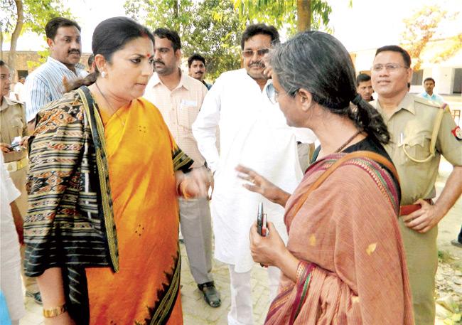 BJP candidate Smriti Irani and Preeti Sahay, PRO of Priyanka Gandhi, entered in a verbal dual as the former objected to her presence at one of the booths in Jagdishpur area in Amethi. Irani complained to the authorities. pics/pti