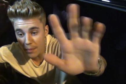 Justin Bieber smack cameras away on Paparazzi's face