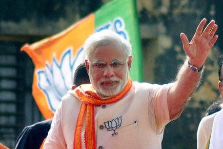 BJP attacks EC over Varanasi curbs, Modi gets grand welcome