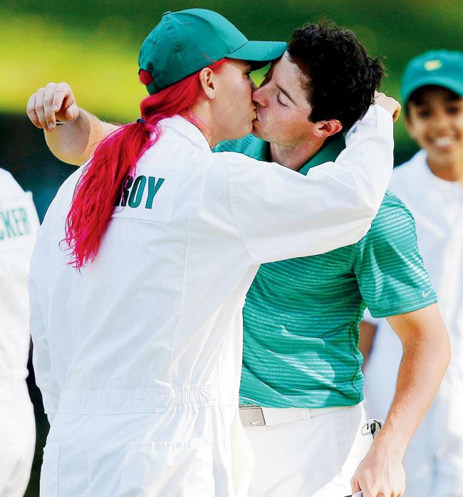 Carolina Wozniacki kisses boyfriend Rory McIlroy during the Par 3 Contest at the Masters in Augusta on Wednesday. Pic/Imagelibrary/EPA