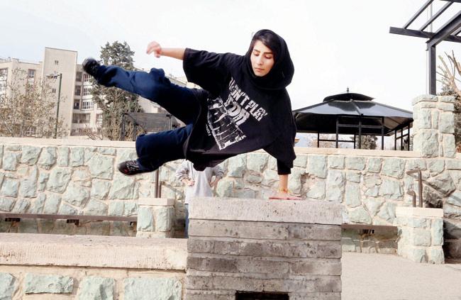 An Iranian woman practices Parkour in Tehran. A group of Iranian women have discovered Parkour which has become their outlet for evading social constraints and dealing with stress. It