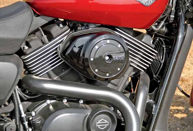 The machined fins of the engine and the air filter case resembling an aircraft fuel tank cap endow the Street 750 with a meaty and great looking  mid-portion