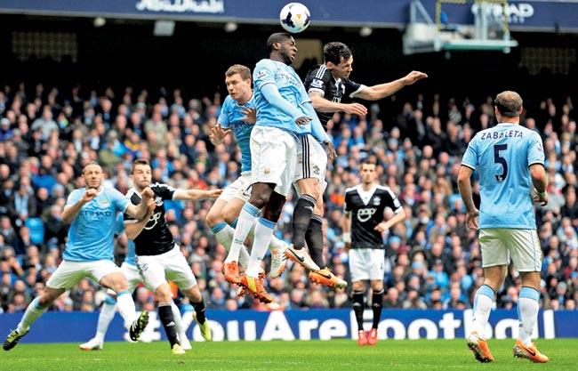 Yaya Toure of Manchester City wins a header under pressure from Jose Fonte of Southampton during their Premier League match at Etihad Stadium on Saturday. Pic/Getty Images