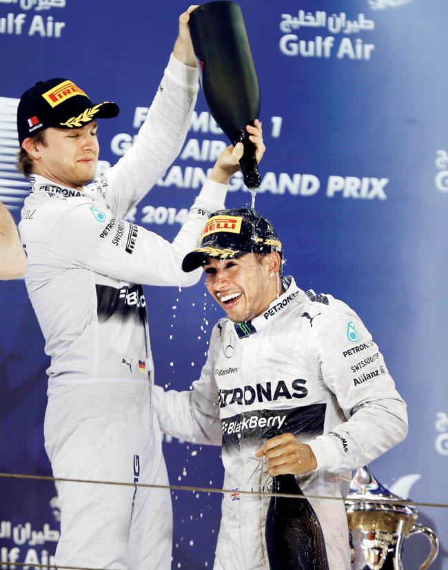 Lewis Hamilton (right) and Nico Rosberg celebrate on the podium yesterday. Pic/Getty Images