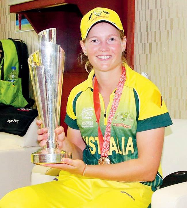 Australia captain Meg Lanning, poses with the trophy in the changing rooms