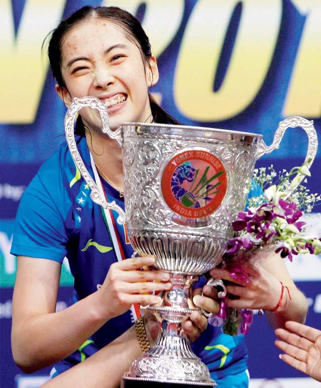 Wang Shixian poses with the trophy after beating World No 1 Li Xuerui in the India Open final in New Delhi yesterday. Pics/PTI