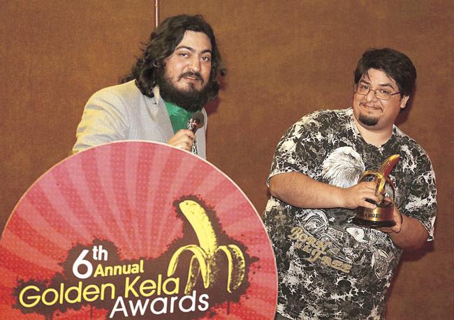 Anant Singh (left) at the Golden Kela awards. The trophy he says is shaped after scouring the markets for a perfect specimen of the fruit