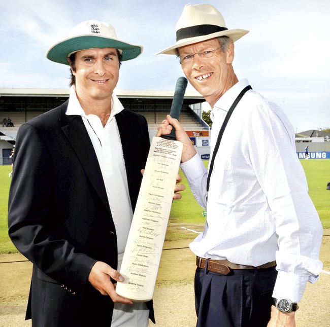 Christopher Martin-Jenkins (who was universally known as ‘CMJ’) (right) gets a signed bat from former England captain Michael Vaughan