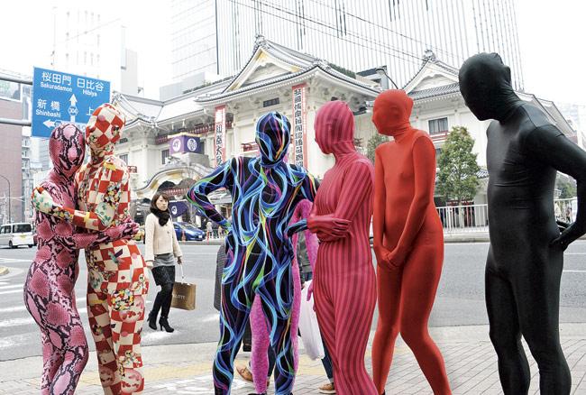 Members of the Tokyo Zentai Club displaying their multi-coloured, skintight Lycra suits. Pic/AFP