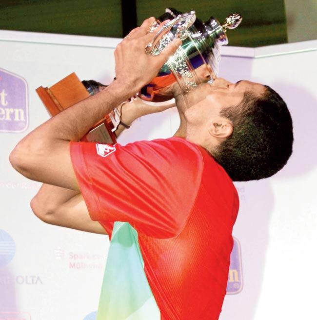 Arvind Bhat holds aloft the trophy after winning the German Open Grand Prix Gold in Mulheim an der Ruhr