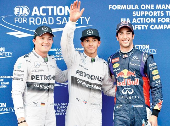 Australian GP pole position winner Lewis Hamilton (centre) of Mercedes with teammate Nico Rosberg (left) and Red Bull’s Daniel Ricciardo after the qualifying session in Melbourne on Saturday