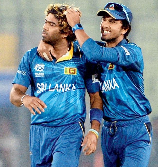 Lasith Malinga celebrates the wicket of Virat Kohli with teammate Dinesh Chandimal yesterday. Pic/AFP