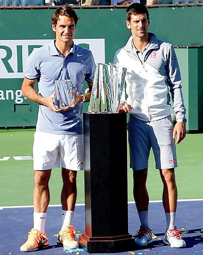 Novak Djokovic (right) and Roger Federer with their trophies at Indian Wells