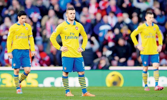 Jack Wilshere of Arsenal and his teammates look dejected after conceding the opening goal against Stoke City on Saturday. Pic/Getty Images