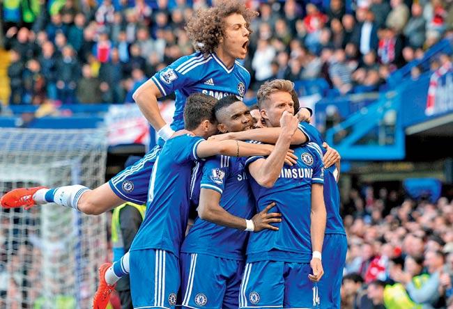 Chelsea players celebrate their second goal scored by Andre Schurrle during their EPL match against Arsenal on Saturday. Pic/AFP
