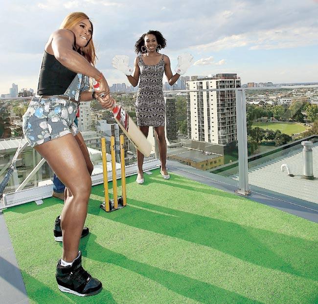  America-s Serena Williams left and sister Venus Williams try their hand at batting during a meet and greet session with the Melbourne Renegades in Melbourne last January. Pic/Getty Images