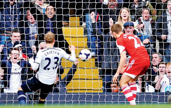 Christian Eriksen (left) scores his second goal yesterday. Pic/AFP