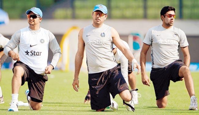 Yuvraj Singh (centre), Suresh Raina and Ravichandran Ashwin (right) warm up during a training session in Dhaka yesterday. Pic/AFP