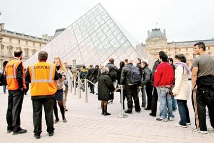 Tourists get caught up in a protest by farmers at the Louvre Museum