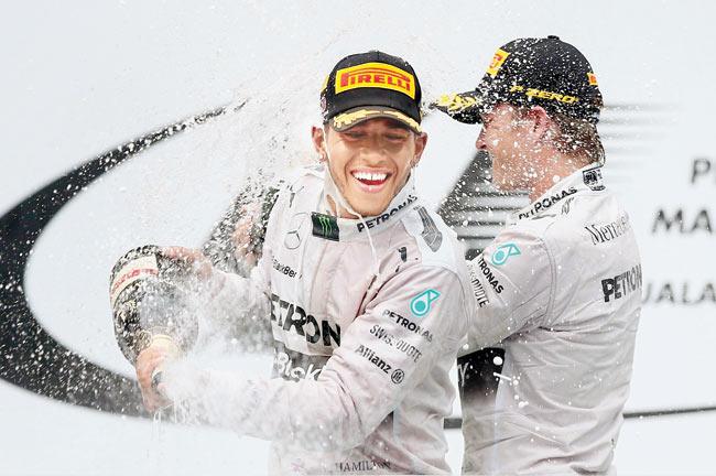 The Mercedes duo of Lewis Hamilton (left) and Nico Rosberg celebrate their victory in the Malaysian Grand Prix at the Sepang Circuit in Kuala Lumpur yesterday. Pic/Getty Images