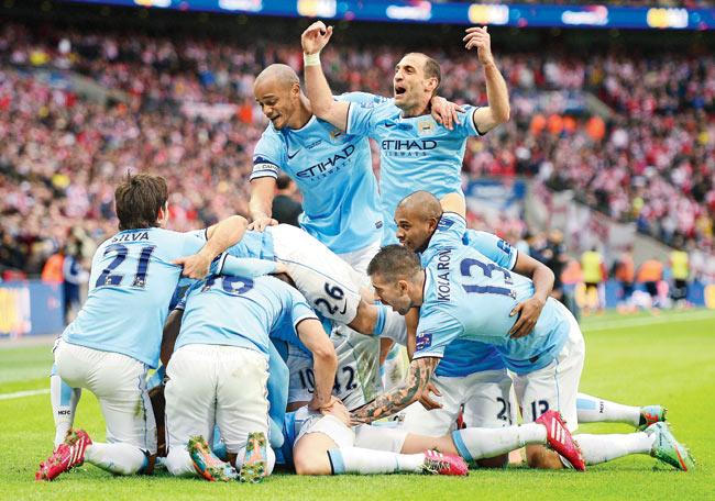 Manchester City players celebrate Samir Nasri