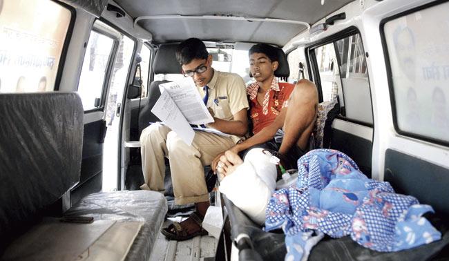 Arun Swami takes his SSC English paper from an ambulance outside RM Bhatt School in Parel, with the help of a writer. He is admitted to KEM Hospital. Pic/Rane Ashish