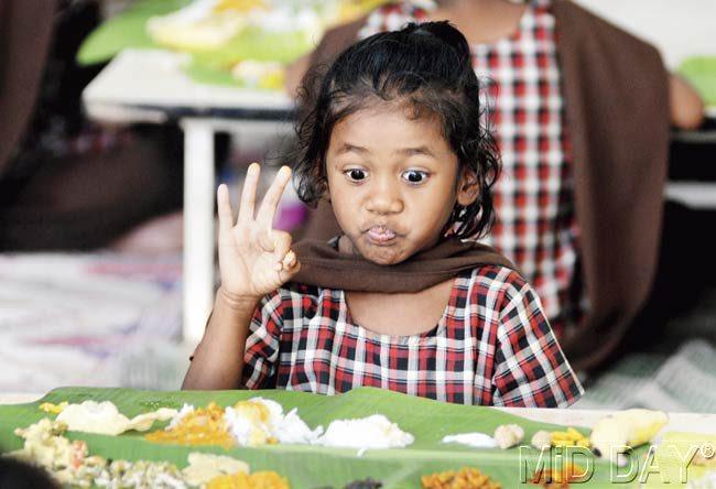 One of the children at the orphanage, delighted at the very sight of the banana-leaf spread. Pic/Satyajit Desai