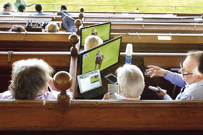 Members watch a race from their boxes. Pics/Raghu Rai