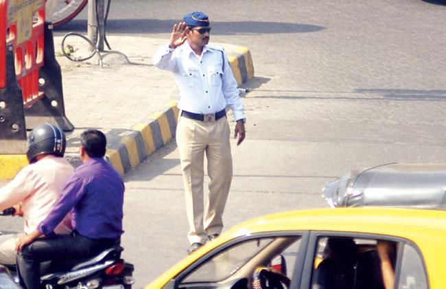 Constable Sanjiv Landage busy controlling traffic at Bandra