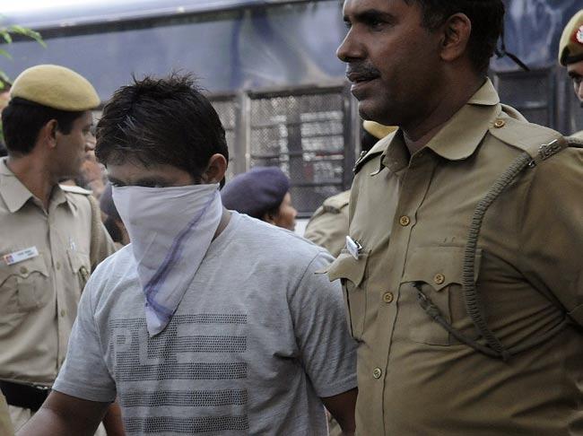 Cops escort Pawan Gupta, one of those convicted in the Delhi gangrape case
